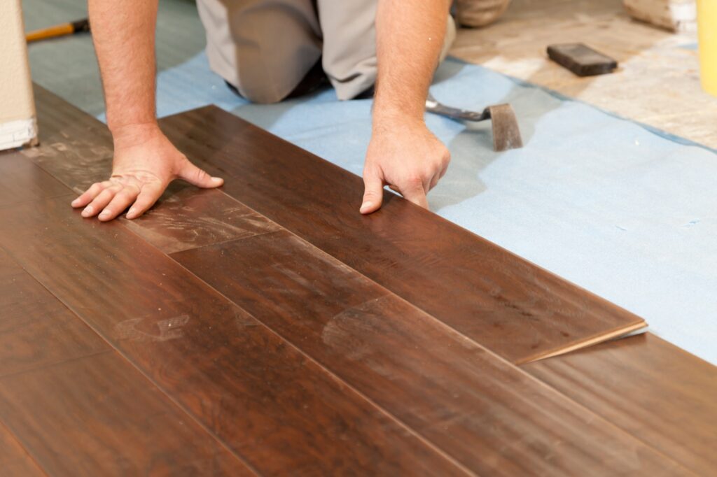 Man Installing New Laminate Wood Flooring